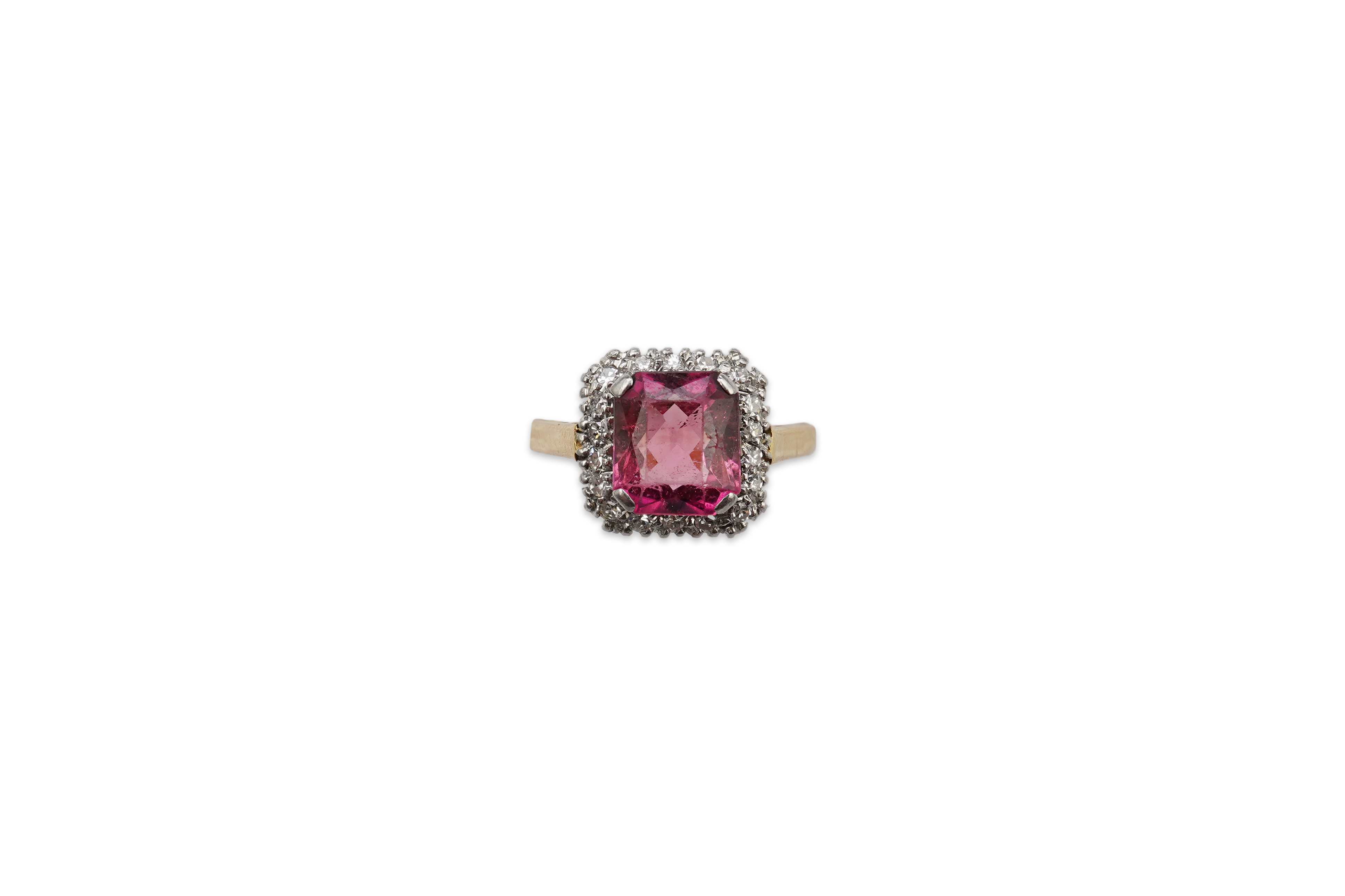 A pink tourmaline and diamond ring, claw-set with a mixed-cut pink tourmaline measuring approximately 8.5 x 7.4 x 4.3mm, within a border of single-cut diamonds totalling approximately 0.20 carats, mounted in gold and pla